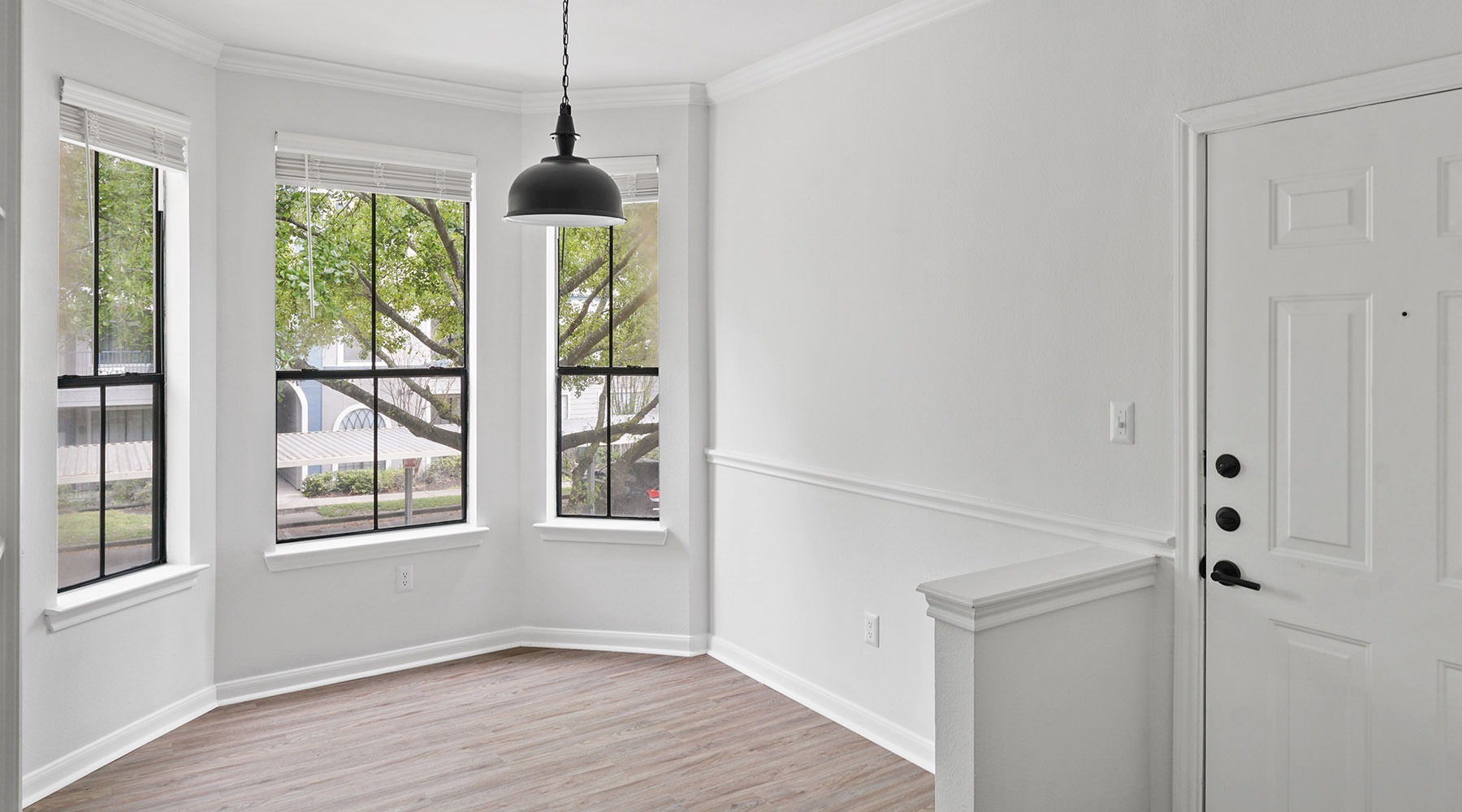 Welcome Home dining room with wood floors and windows