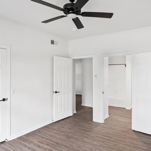 Beautiful bedrooms to fit every need a room with white doors and a ceiling fan