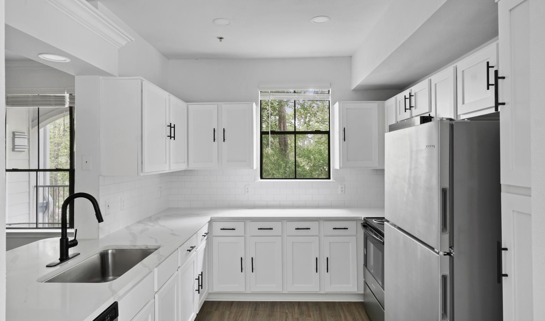 Spacious kitchens with thoughtful details a kitchen with white cabinets